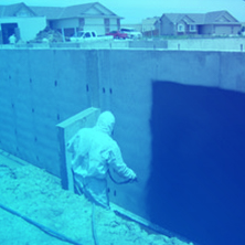 Spraying Waterproofing Material on exterior walls